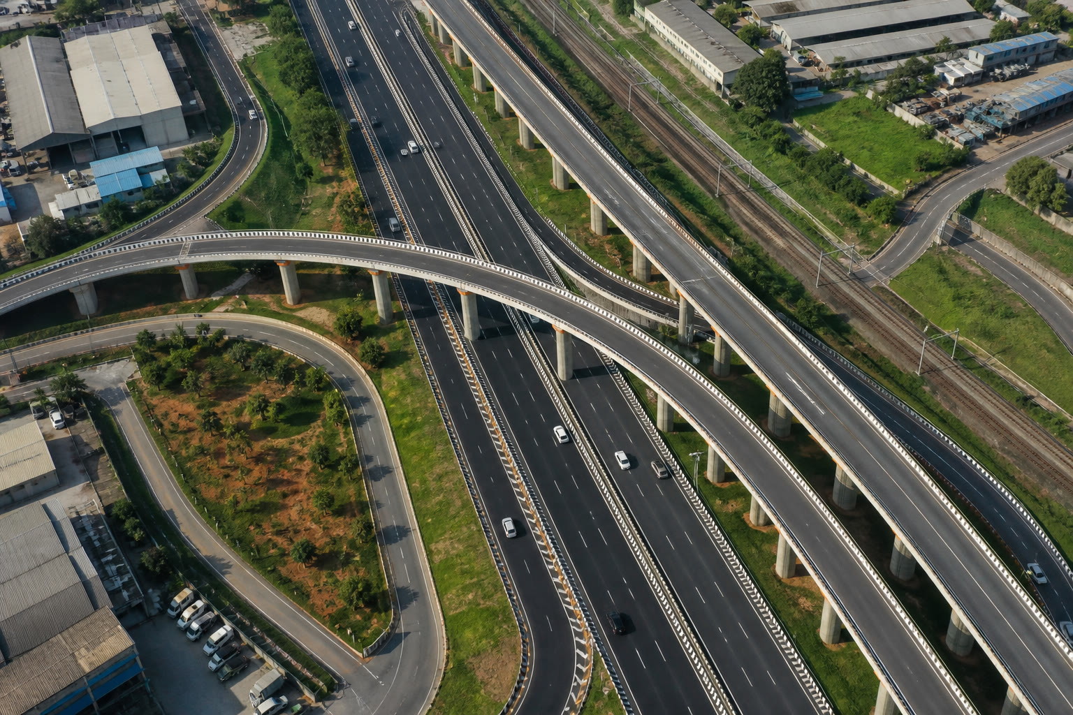 Aerial view of a multi-level highway interchange — the kind of strategic-road portfolio TerraForge holds as land and programme together